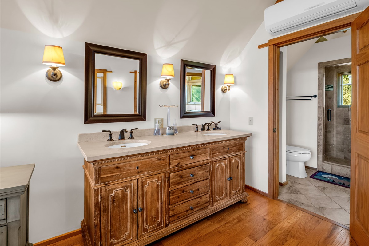 Upstairs master bathroom with walk in shower with five shower heads and side by side sinks.!