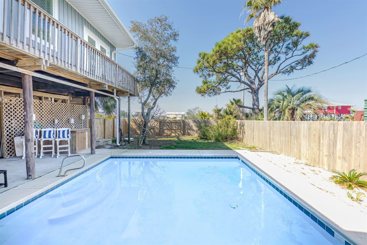 Outdoor Oasis: Dive into relaxation with your private pool surrounded by lush greenery!