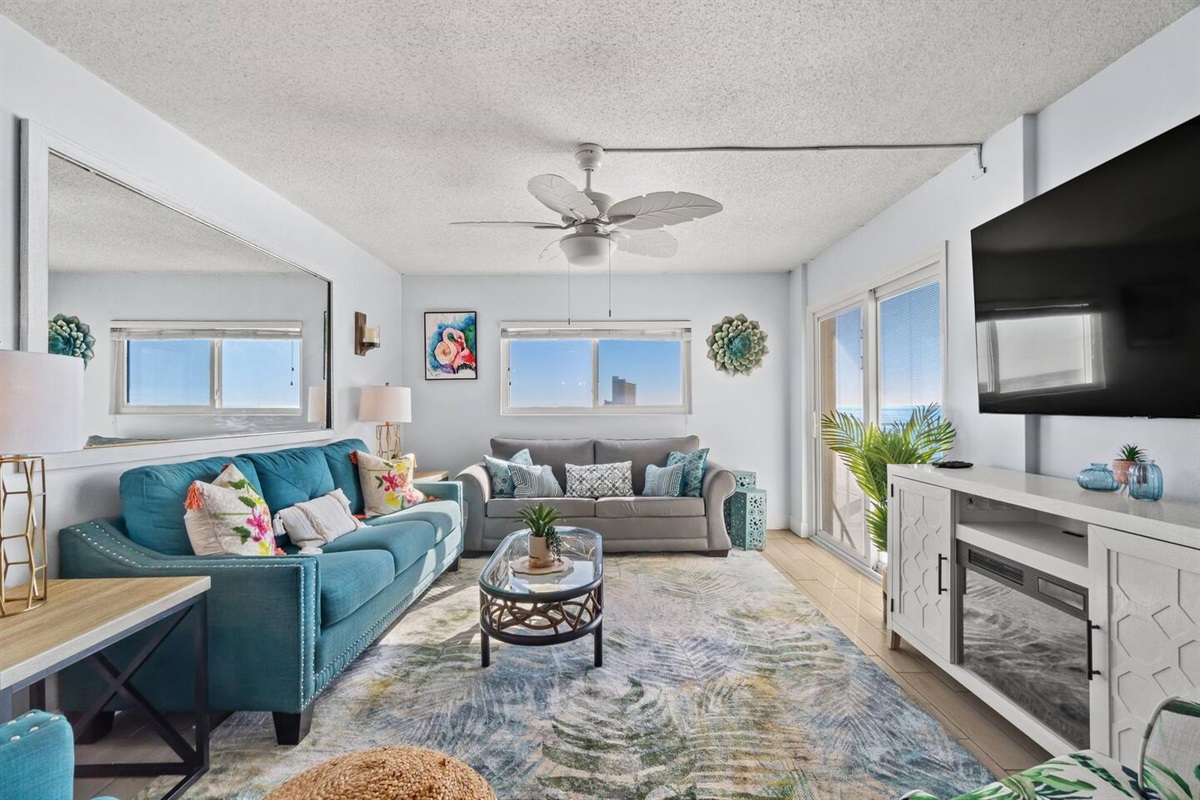 Spacious living room with electric fireplace!  Enjoy the views and relax with your friends and family!