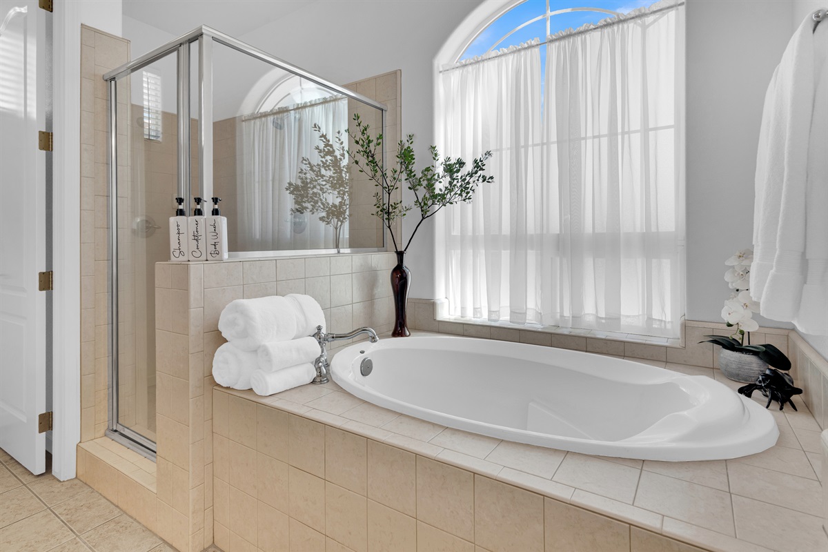 Primary ensuite bathroom creates a spa-like experience. Double sinks, plenty of counter space, soaking tub and separate shower make for a pleasant experience.