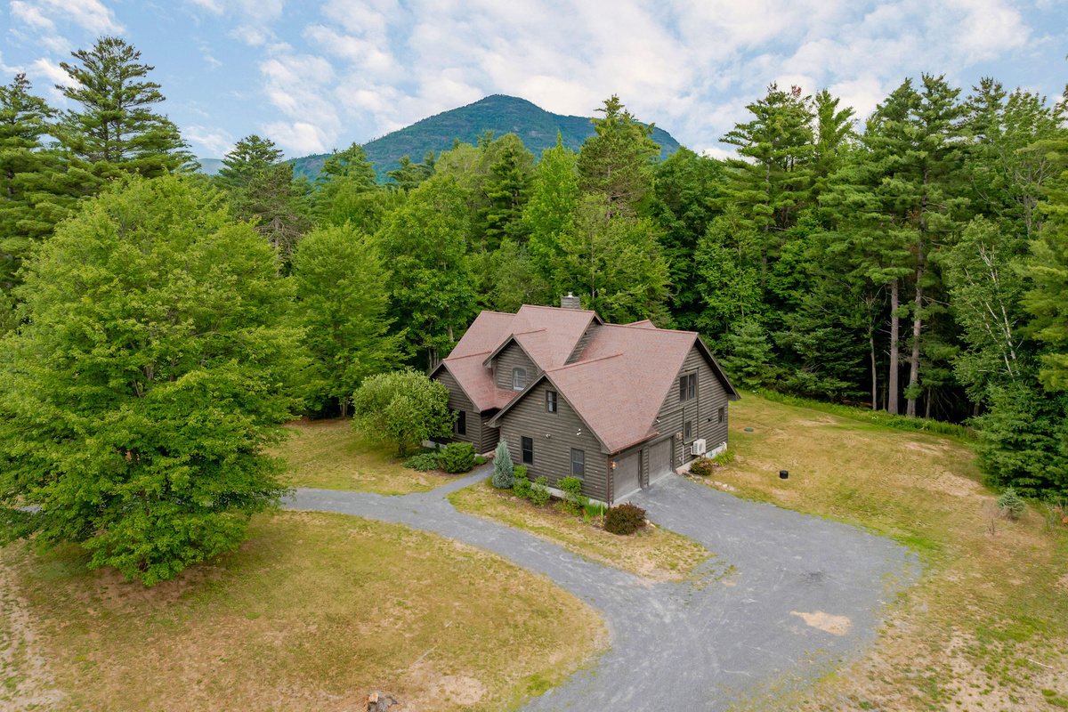 Nestled on a private wooded lot with beautiful mountain views, this spacious Adirondack retreat offers the perfect setting for year-round getaways near Whiteface Mountain and Lake Placid.