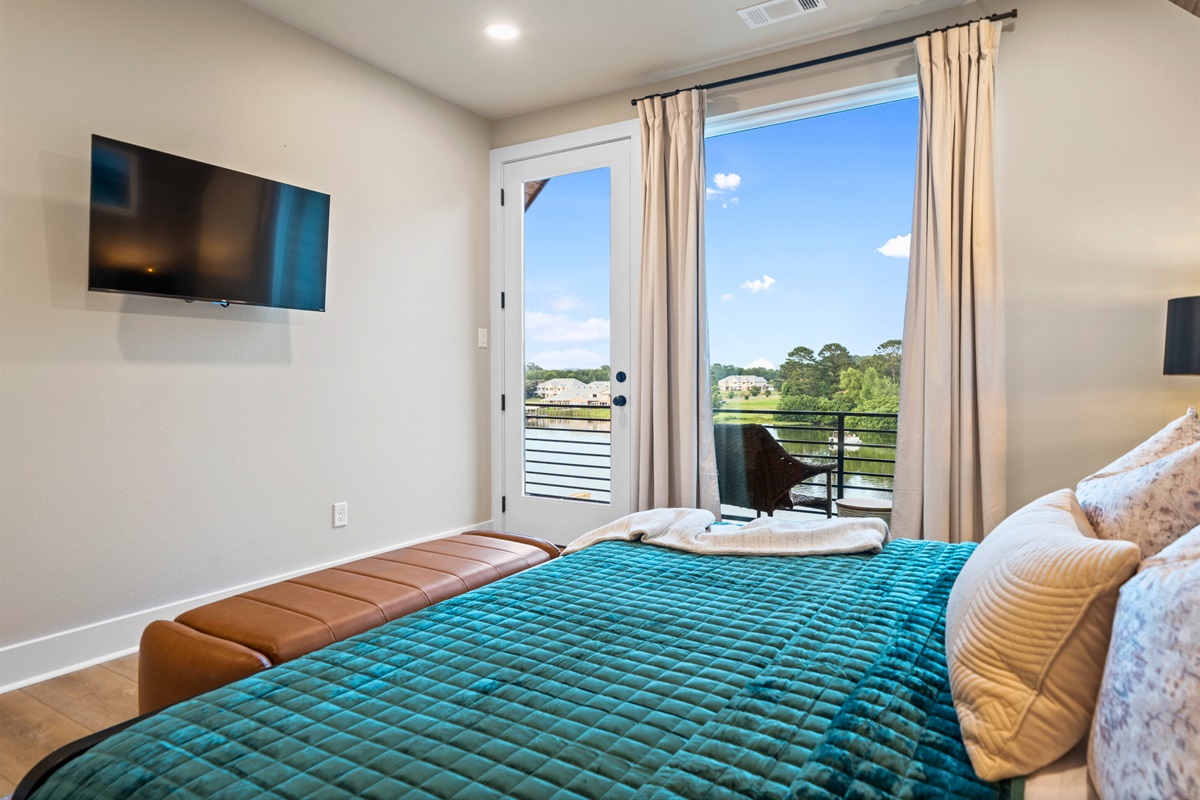 This bedroom features a king-sized bed with luxurious bedding and plush pillows, ensuring a restful and comfortable sleep.