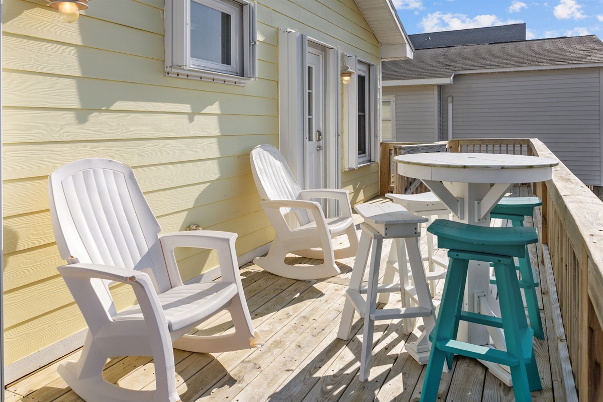 Outdoors seating with rocking chairs and bar-height table