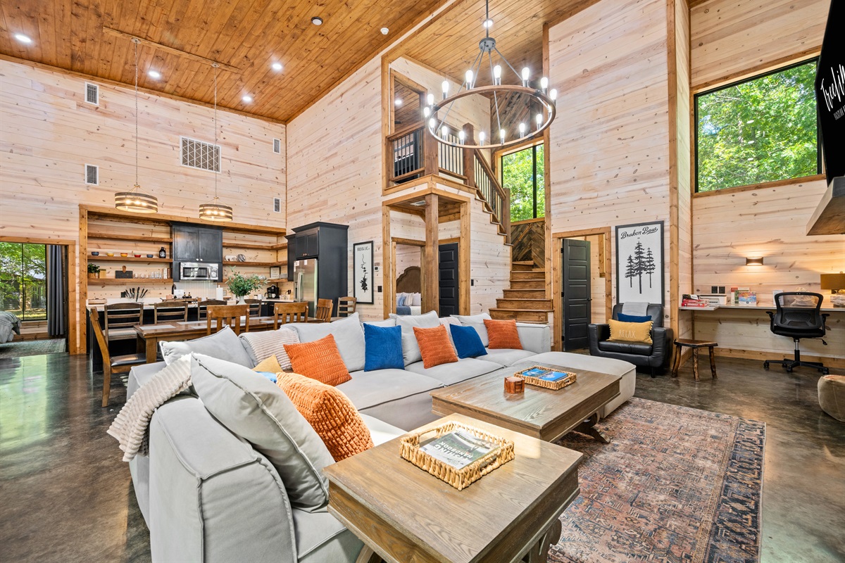 Welcome to Oklahoma Smokeshow - modern cabin vibes, open layout, cozy textures, and forest views.