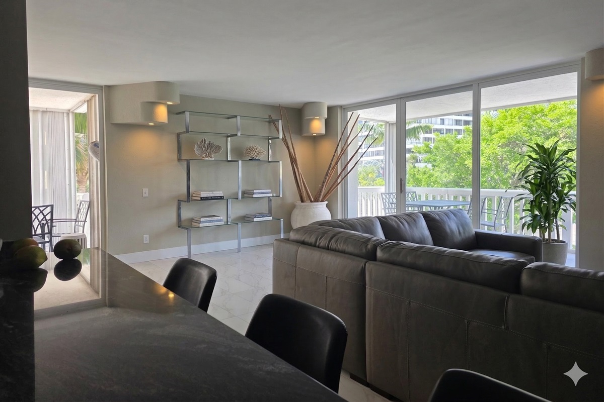 Living room with two balconies-one walks out to the pool/ocean in 2 minutes! Second balcony overlooks the street in front of the building. This unit is a corner unit.