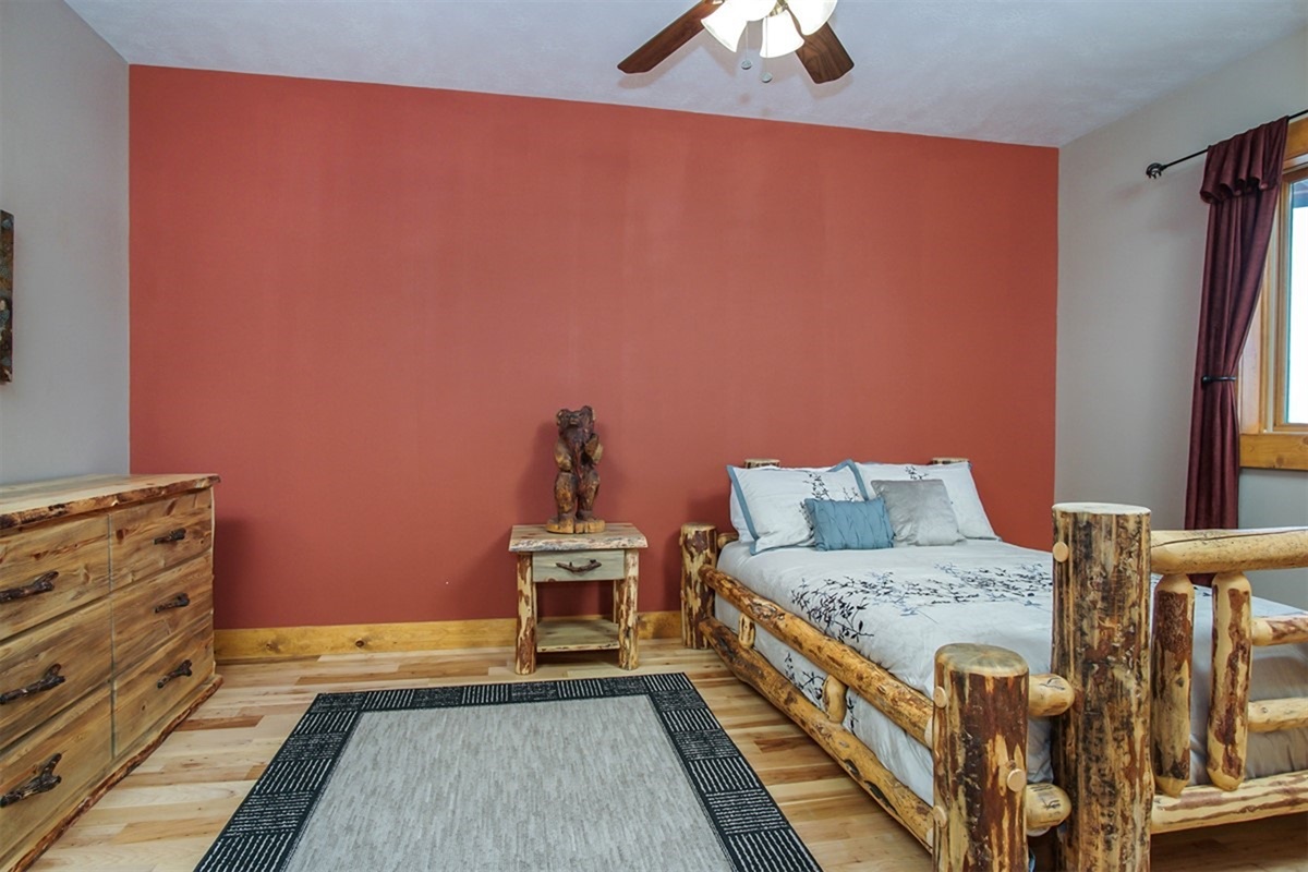 Spacious bedroom with double bed, comfortable furnishings, and natural light