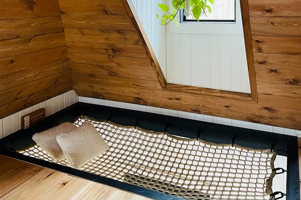 This dreamy second-story loft is accessible only by a ship’s ladder, adding an adventurous yet intimate feel.