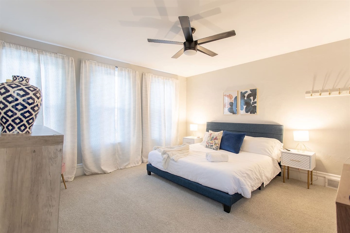 Discover the King Bedroom, a spacious room on the second floor with king bed flanked by nightstands with lamps.