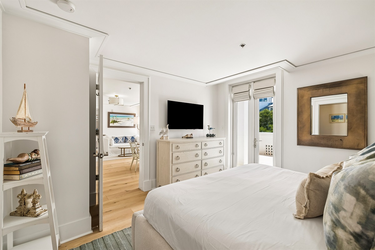 Enjoy a wall mounted TV, large dresser, and direct access to the terrace.