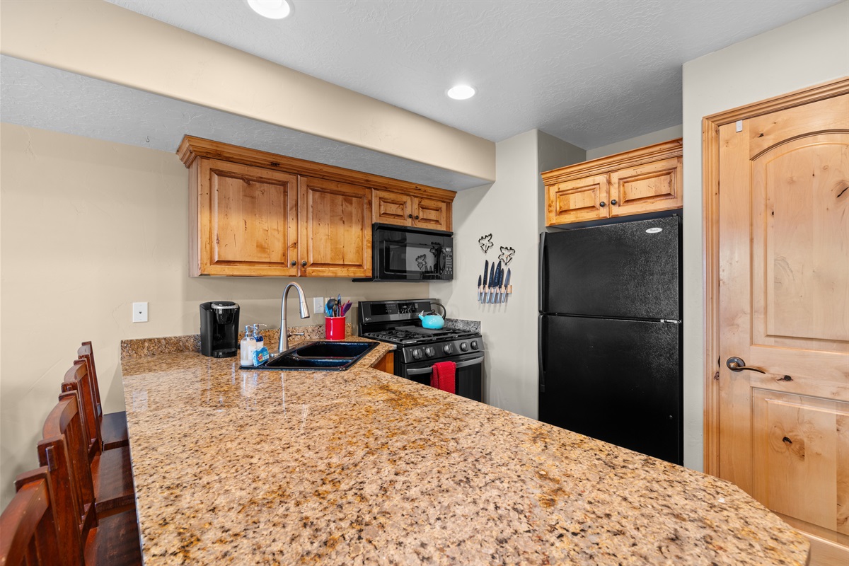 Spacious kitchen with granite countertops, full-size appliances, and plenty of prep space.