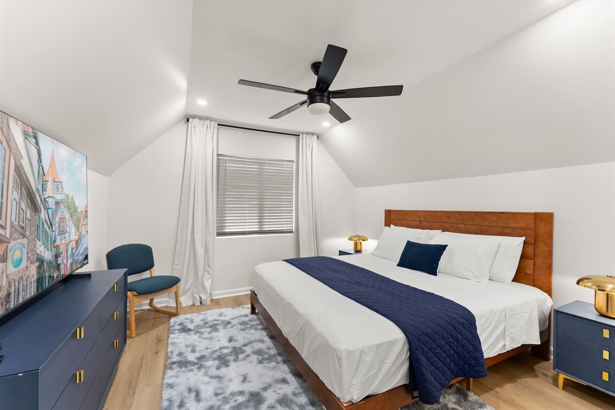 Upstairs king bedroom with a large TV—comfortable and perfect for relaxing.