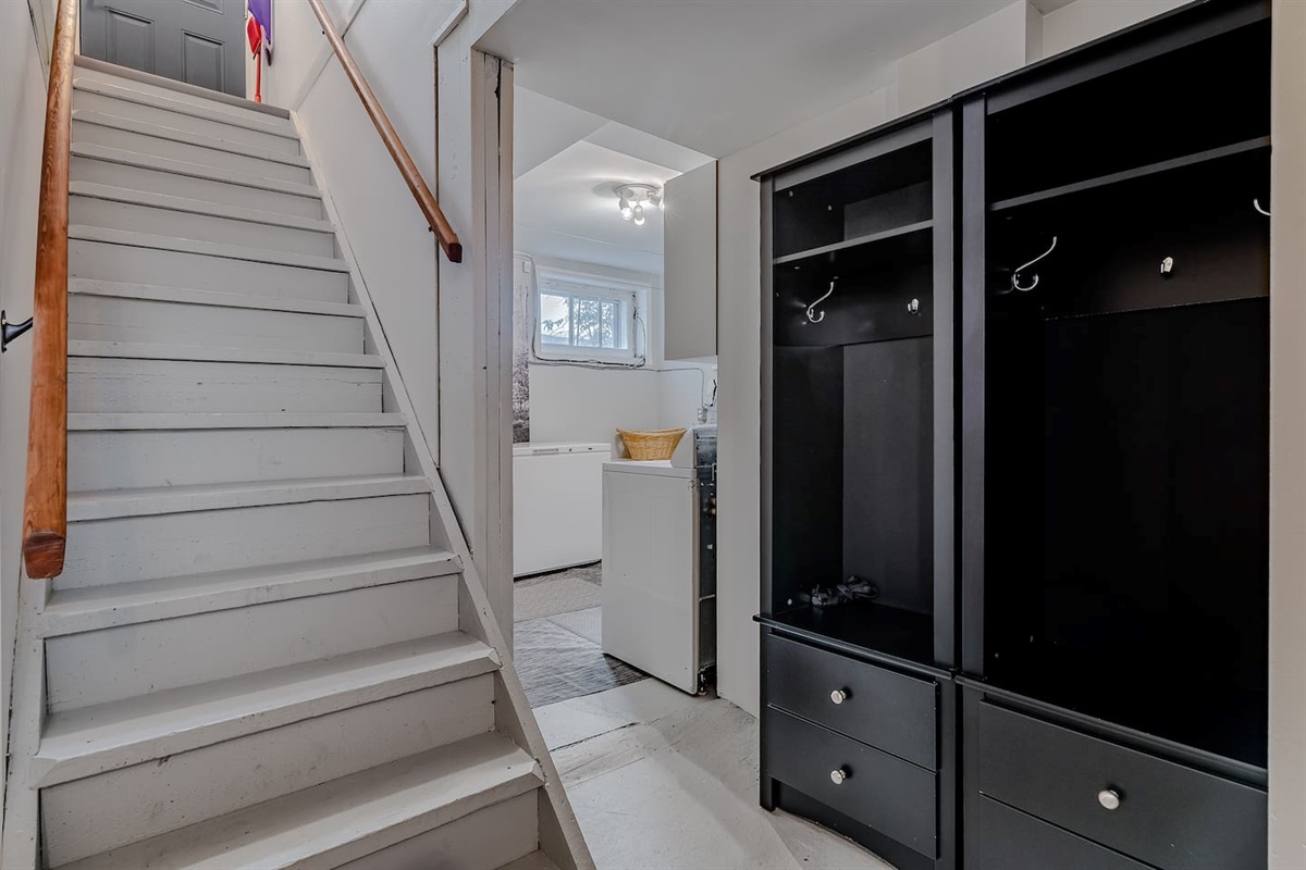 Access the private suite and shared laundry via original 1950s stairs. They are naturally steeper, so please use the sturdy handrails on both sides for safety. Cubbies to store your items.