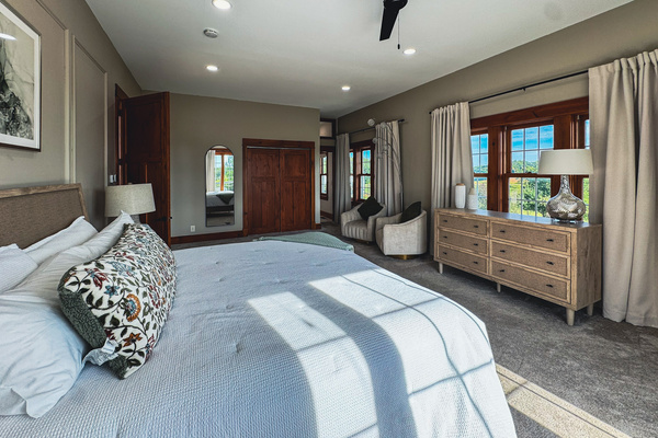 Main-level primary suite with a king bed and seating area.