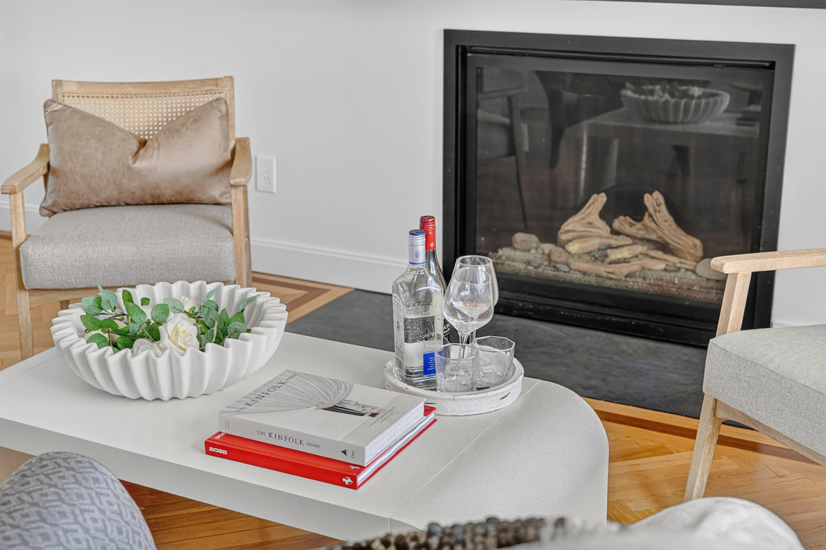Cozy gas fireplace creates the perfect atmosphere for relaxing after a day by the ocean.