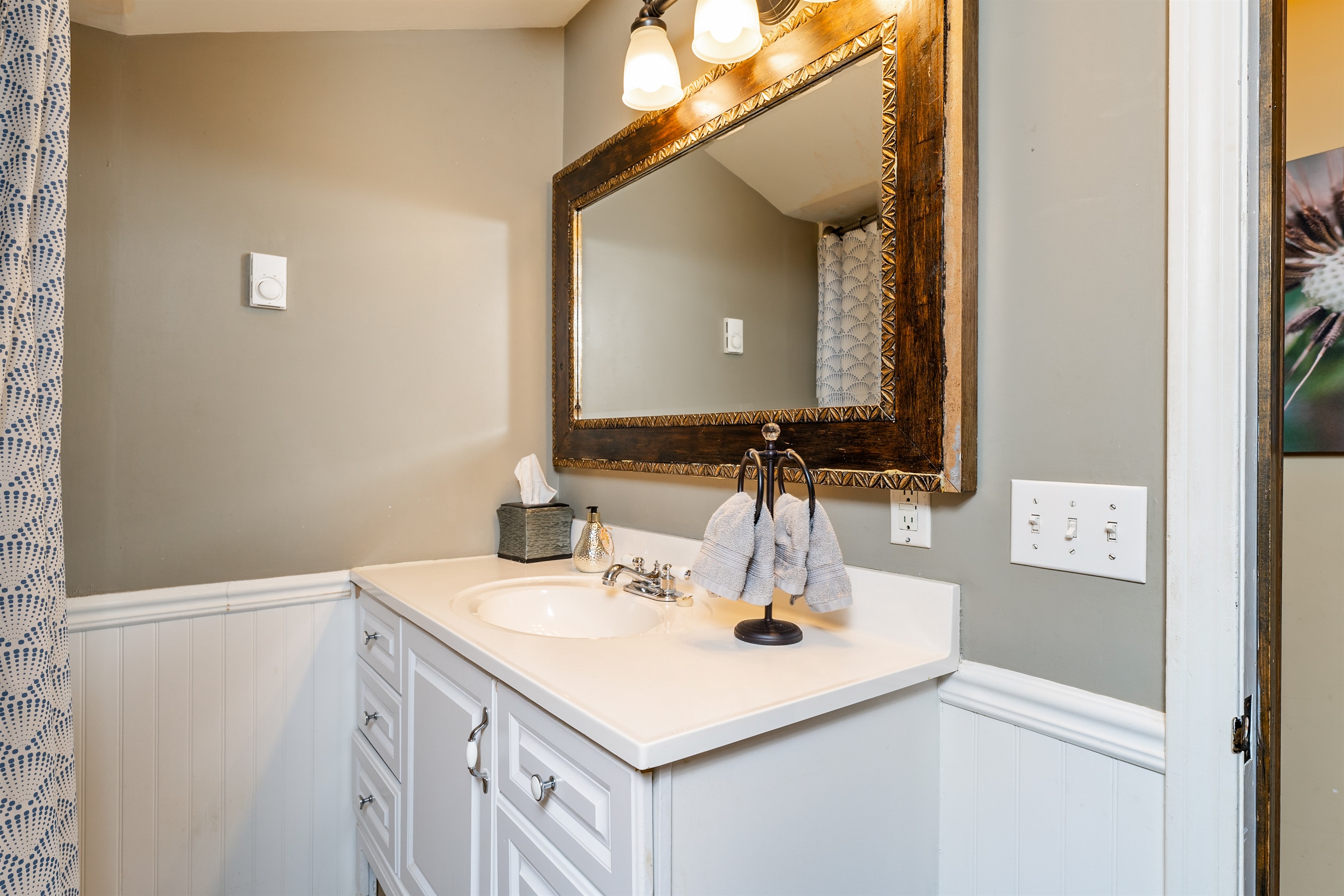 Clean and functional upstairs bathroom with a tiled shower/tub combo, stocked towels, and modern touches for guest comfort.