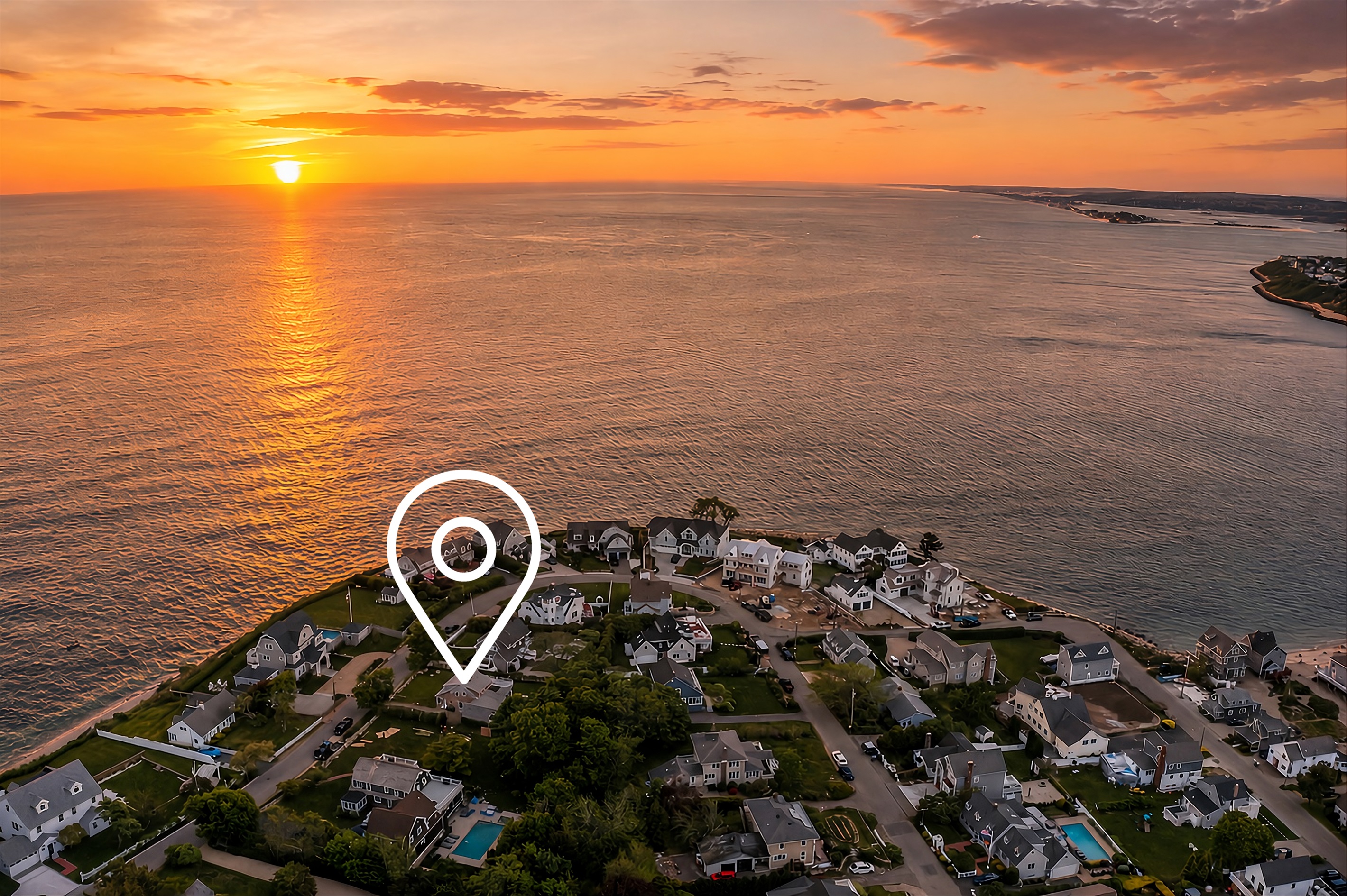 A sunset view over the property, casting warm golden light across the house and surrounding landscape.