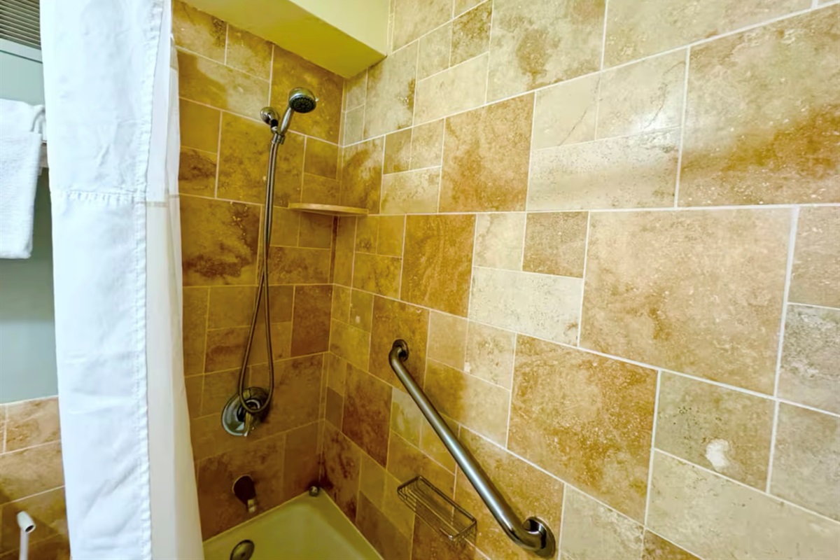 Roomy travertine shower with bathtub