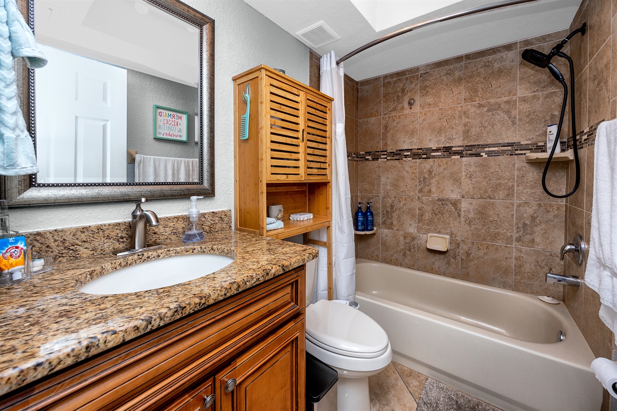 spacious bathroom that is fully stocked