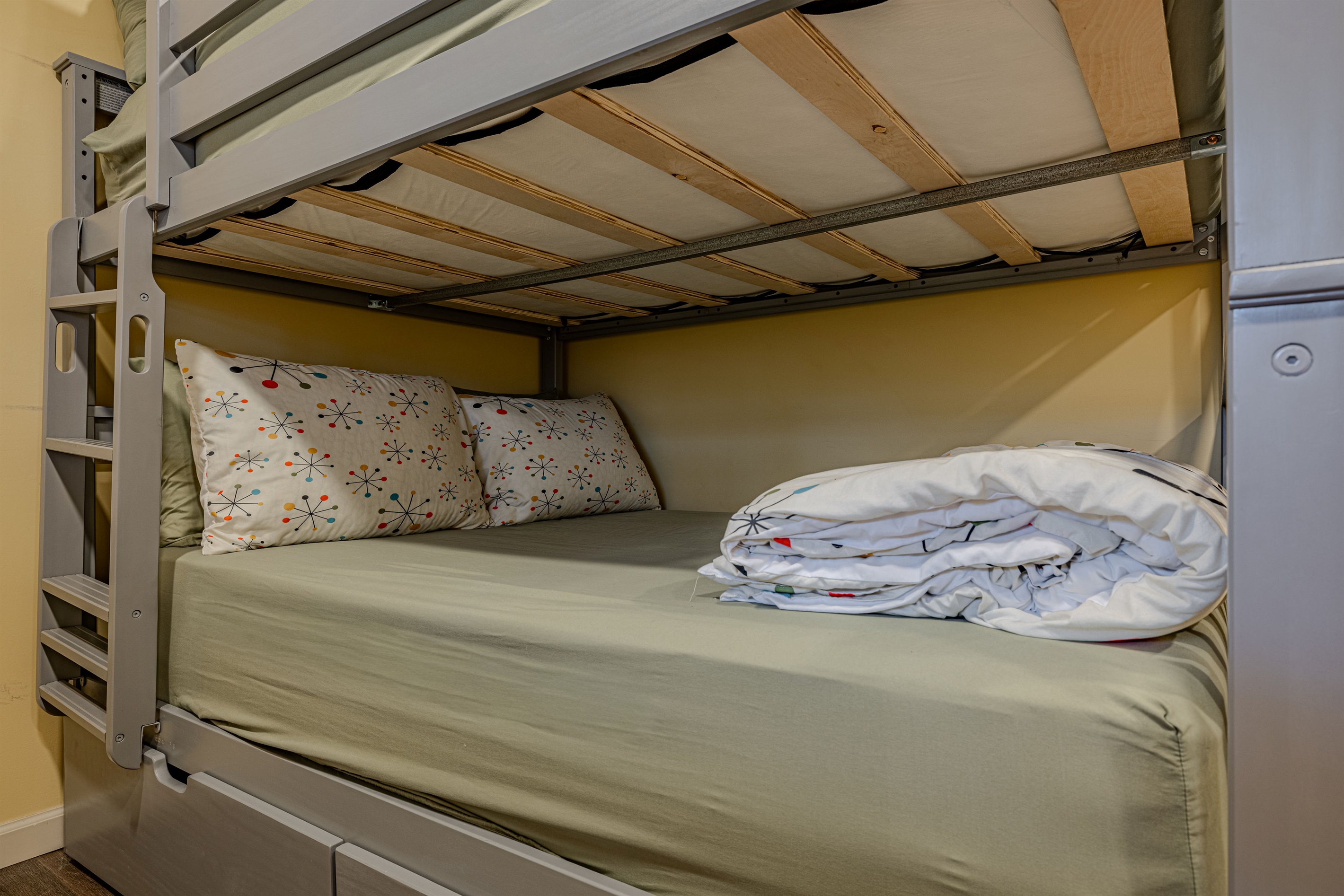 This versatile sleeping space features a full-sized lower bunk and a twin top, perfect for families traveling together.