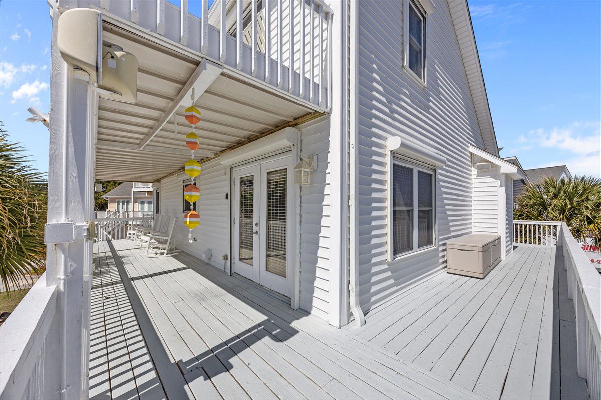 Covered balcony with rocking chairs perfect for morning coffee or evening relaxation