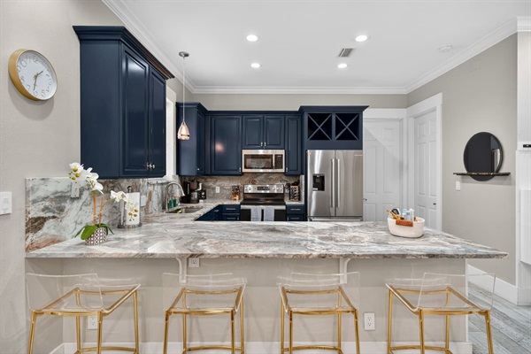 Fully stocked kitchen with blenders, food processors, toaster, baking and cooking supplies