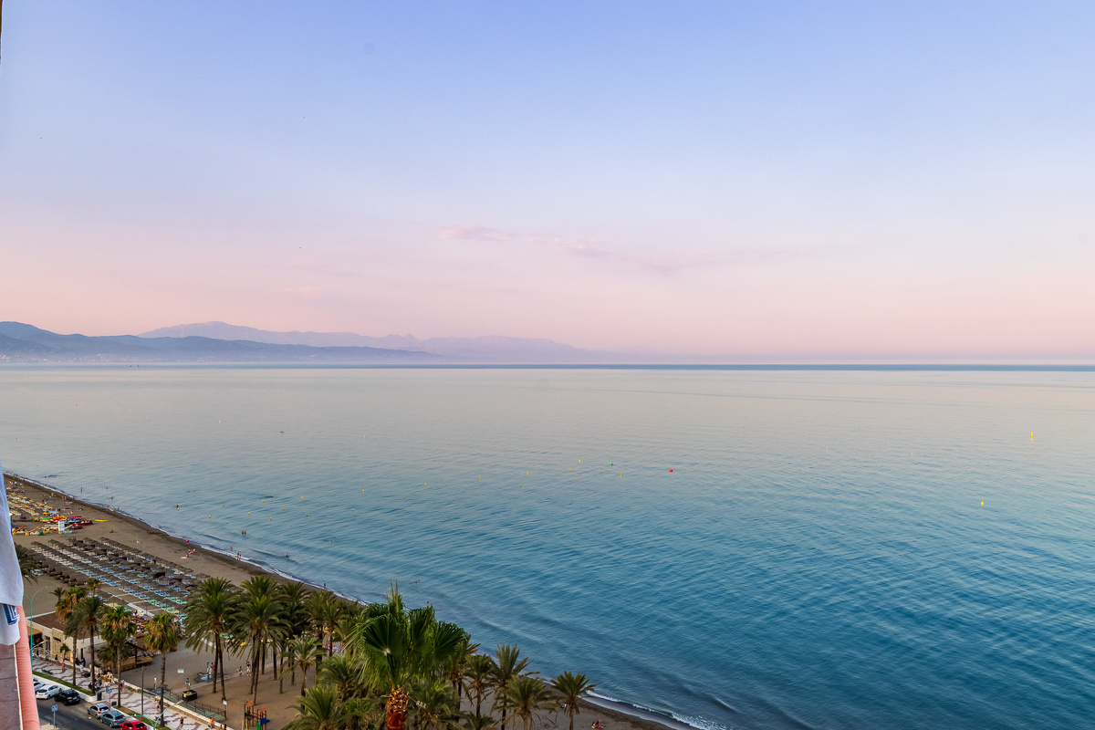 Soft sunset colours over the Mediterranean and coastline.