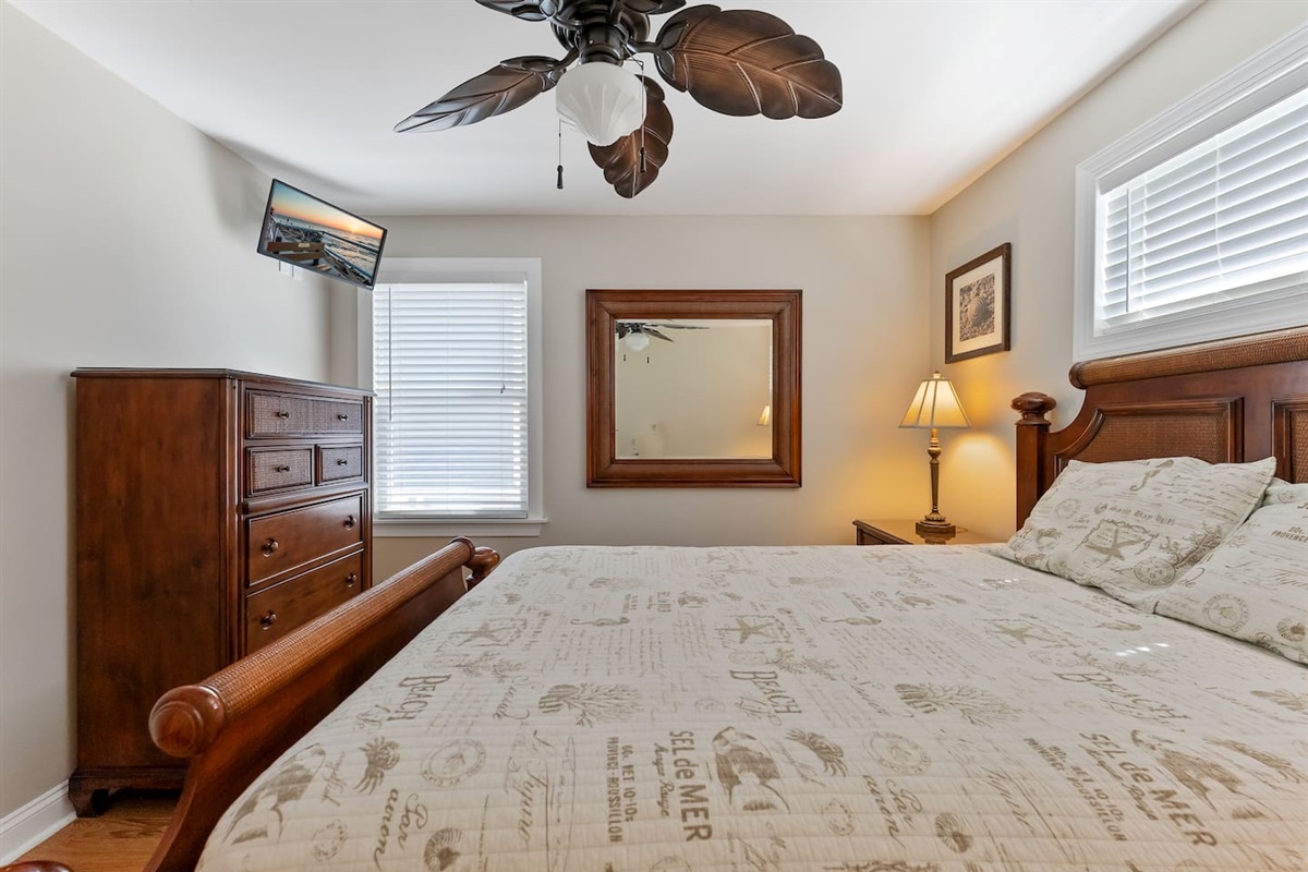 Queen Size Bed with storage, and TV and ceiling fan. 