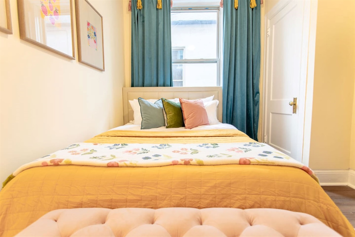 Comfortable queen-sized bedroom offering a restful retreat with ample space and natural light.