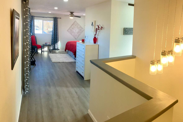 Access to the the upstairs bedroom featuring a comfortable king‑size bed, walk‑in closet, and a private full bathroom. Blackout curtains ensure a restful, uninterrupted sleep.