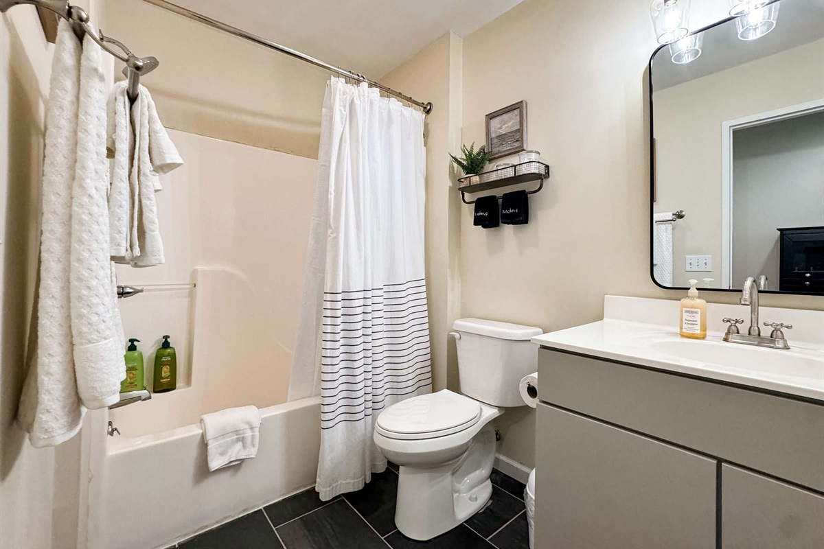 The upstairs bathroom is a shared bathroom for the two upstairs bedrooms. The bathroom features a tub/shower combination, toilet, and sink. 