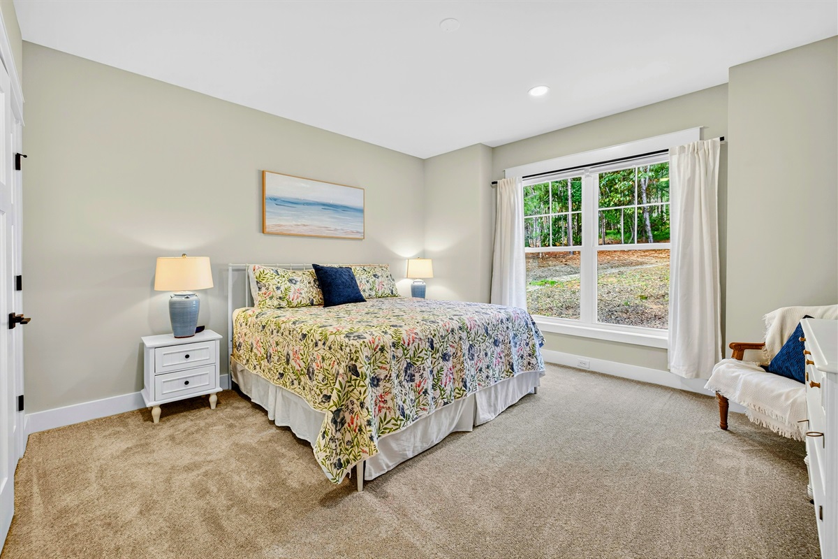 The 2nd main level king suite blends crisp, fun colors with bright, luxurious bedding and a stately antique dresser to add timeless charm to the suite. We also coordinated the same colors in this suite bath to create an inviting retreat.