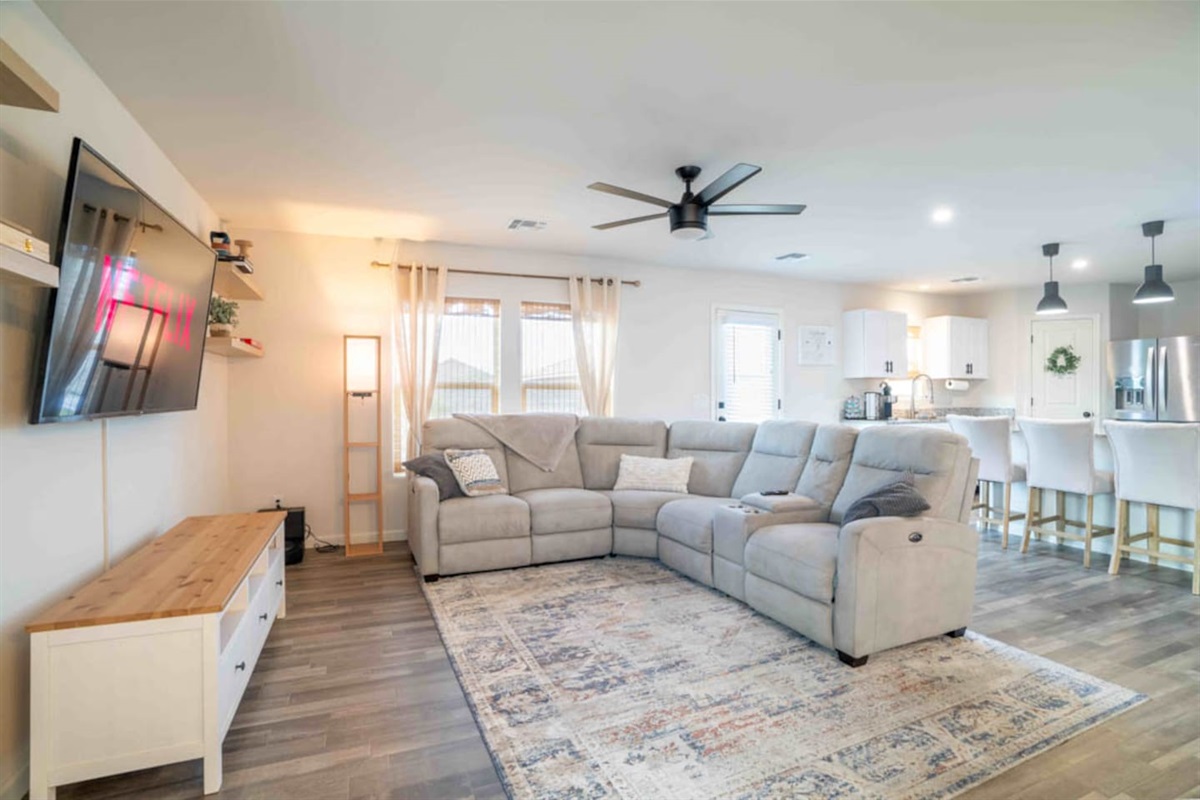 Comfortable reclining sofas with center console in living room. 