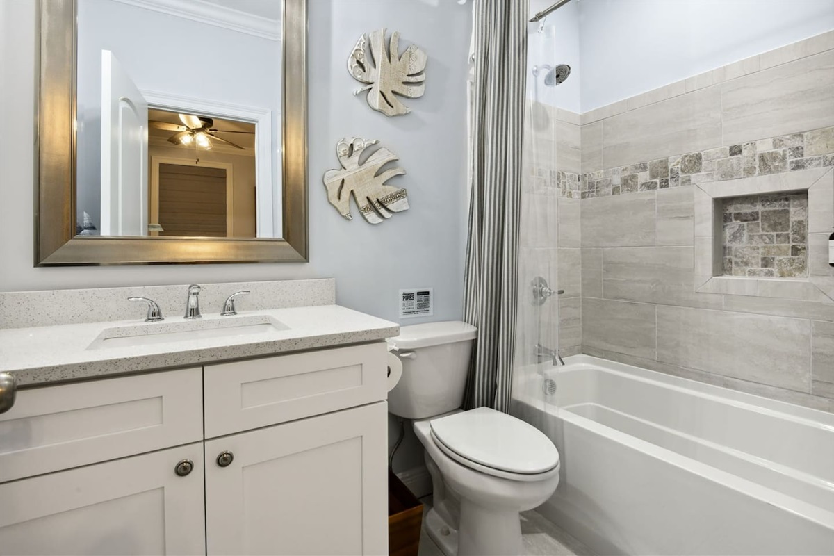 Clean, modern bathroom with a tiled tub/shower combo and sleek vanity.