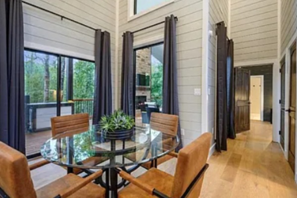 Dining area with scenic outdoor views and direct deck access.