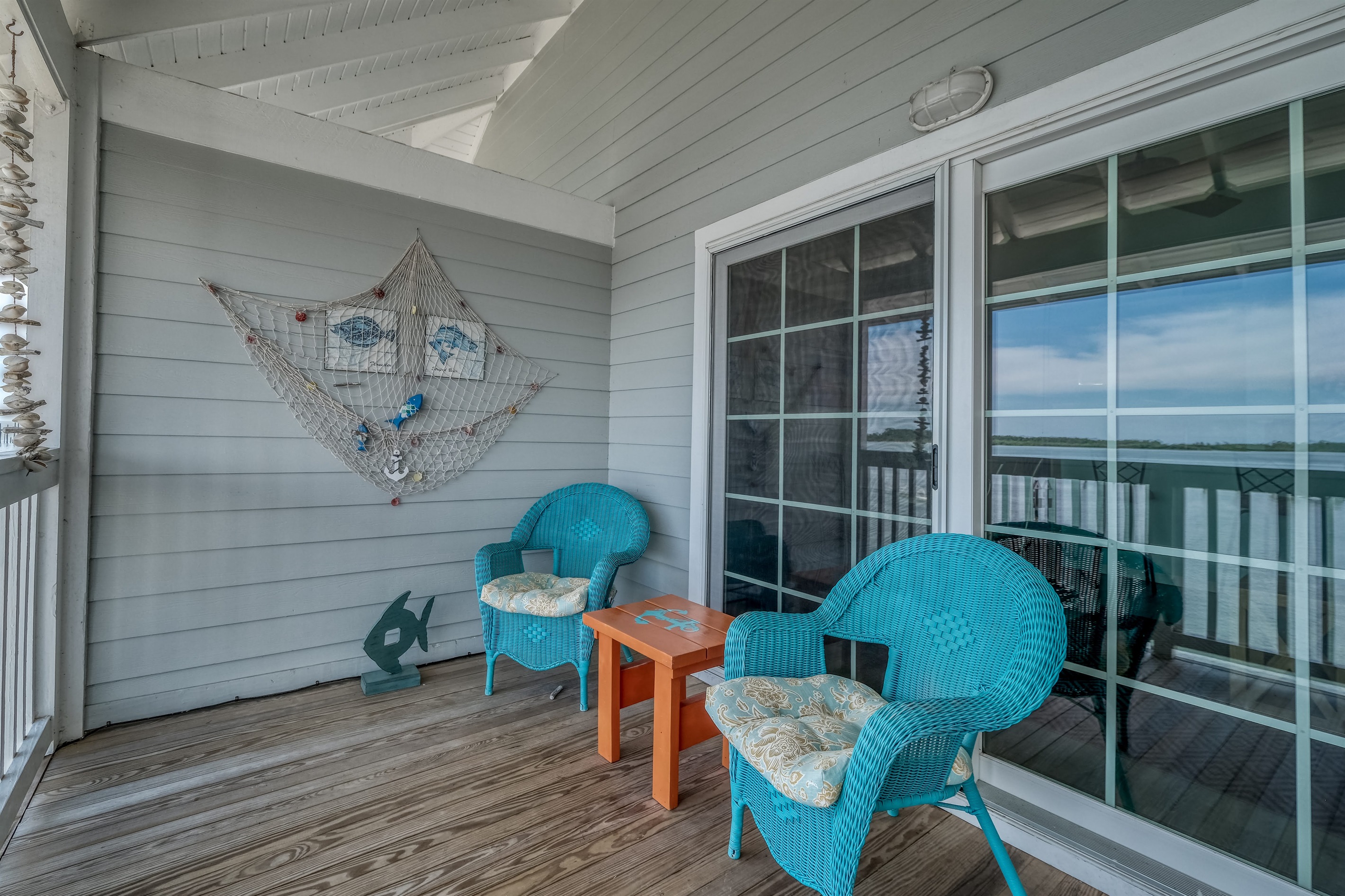 Sliding glass doors of of living space lead to a private porch