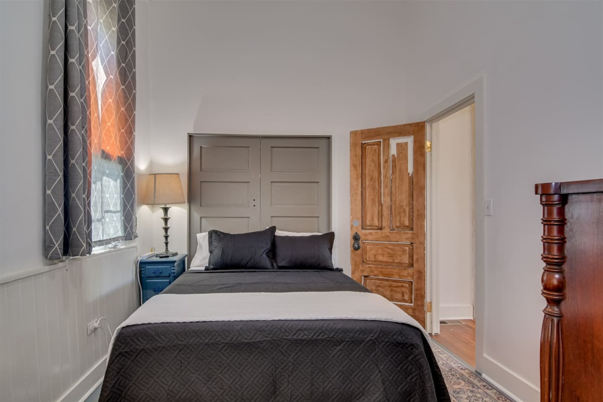 Spacious bedroom with modern black bedding.