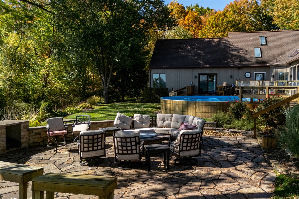Beautiful backyard oasis featuring a firepit, seating area, and sweeping lakeside views. Perfect for unforgettable evenings under the stars.