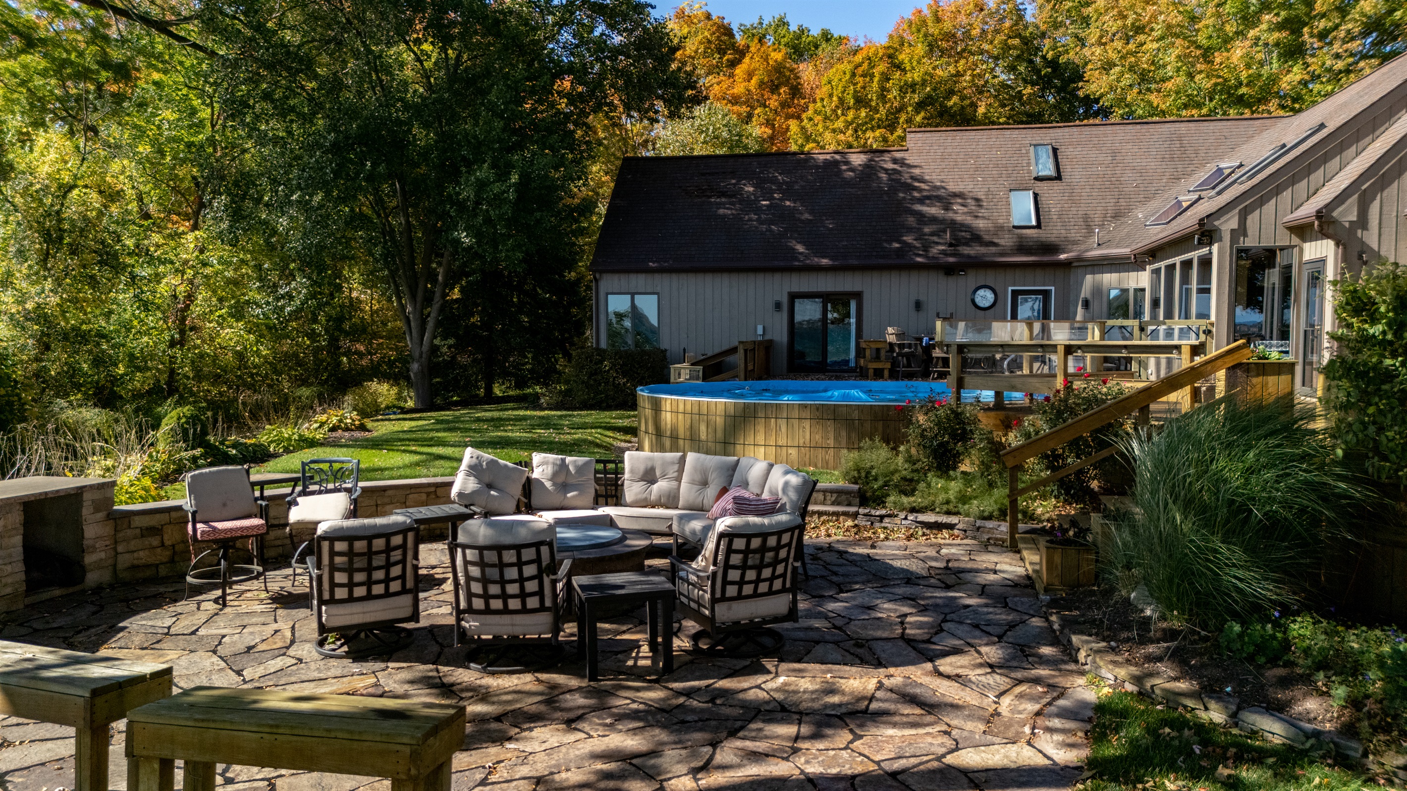 Beautiful backyard oasis featuring a firepit, seating area, and sweeping lakeside views. Perfect for unforgettable evenings under the stars.
