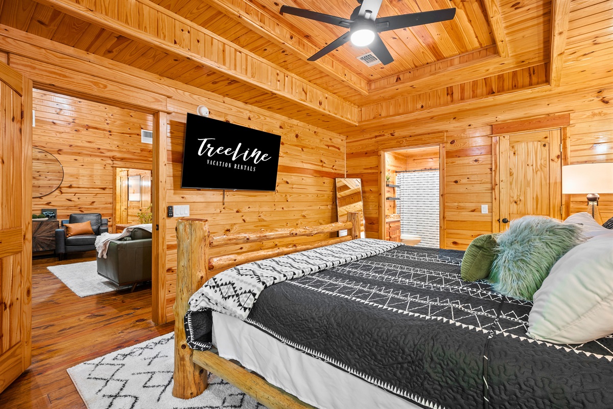 Bedroom 2 also features a TV and connects to the main space, with cozy wood tones and thoughtful decor.