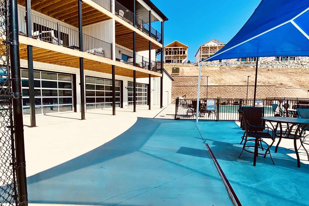 Indoor pool is right beside the larger outdoor pool and the playground just inside these garage doors.