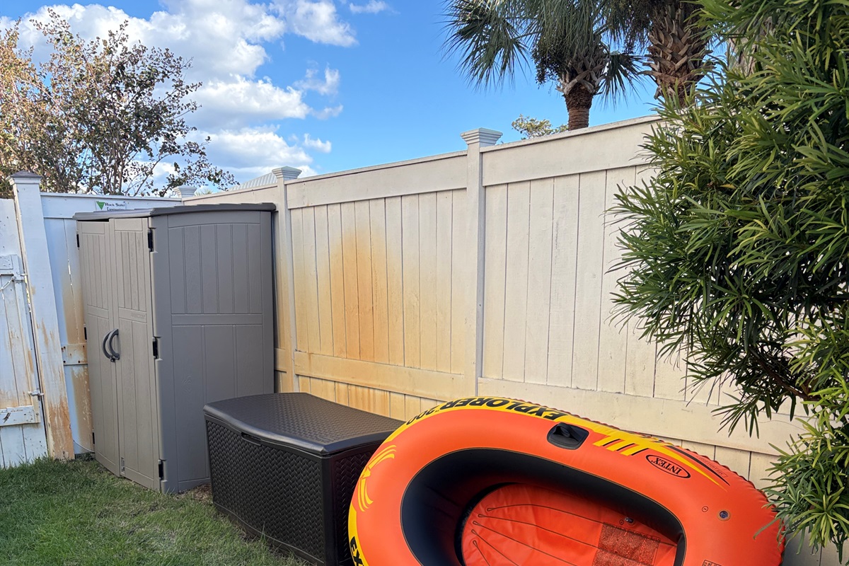 Fully fenced backyard with outdoor storage and pool accessories.