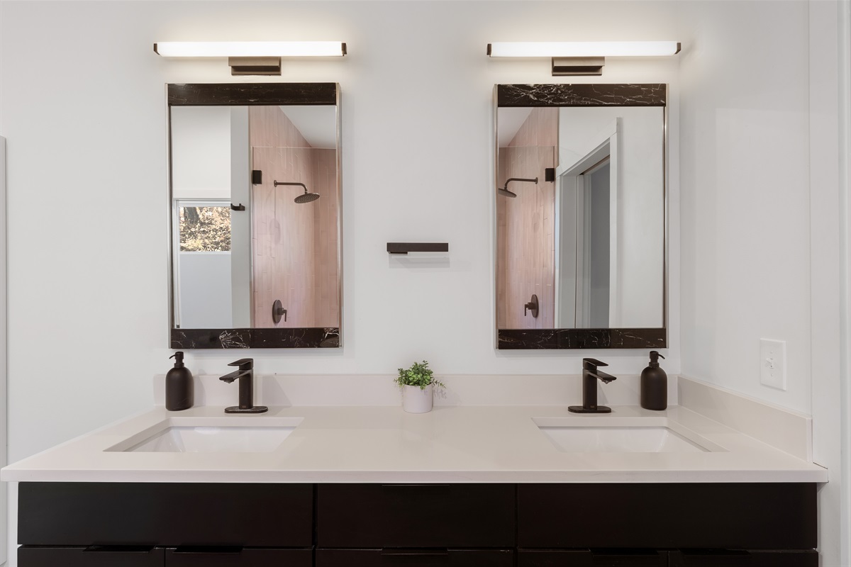{Spa Bath - Glass House} Dual sinks with matte-black fixtures and warm lighting create a polished, spa-level experience