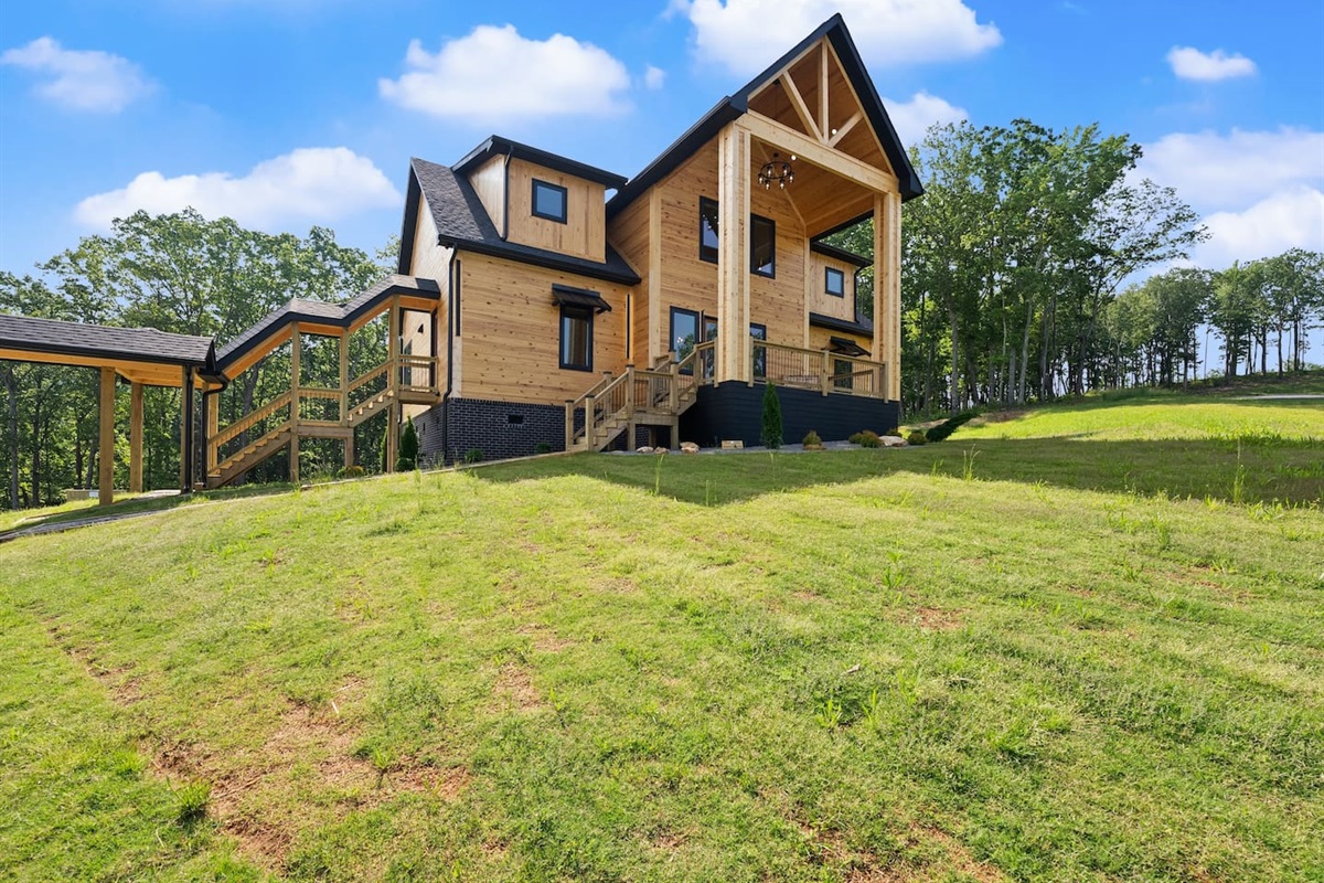 From the gently sloped yard to the sleek carport and stairway entry, every detail here is crafted for convenience and style in a natural setting.