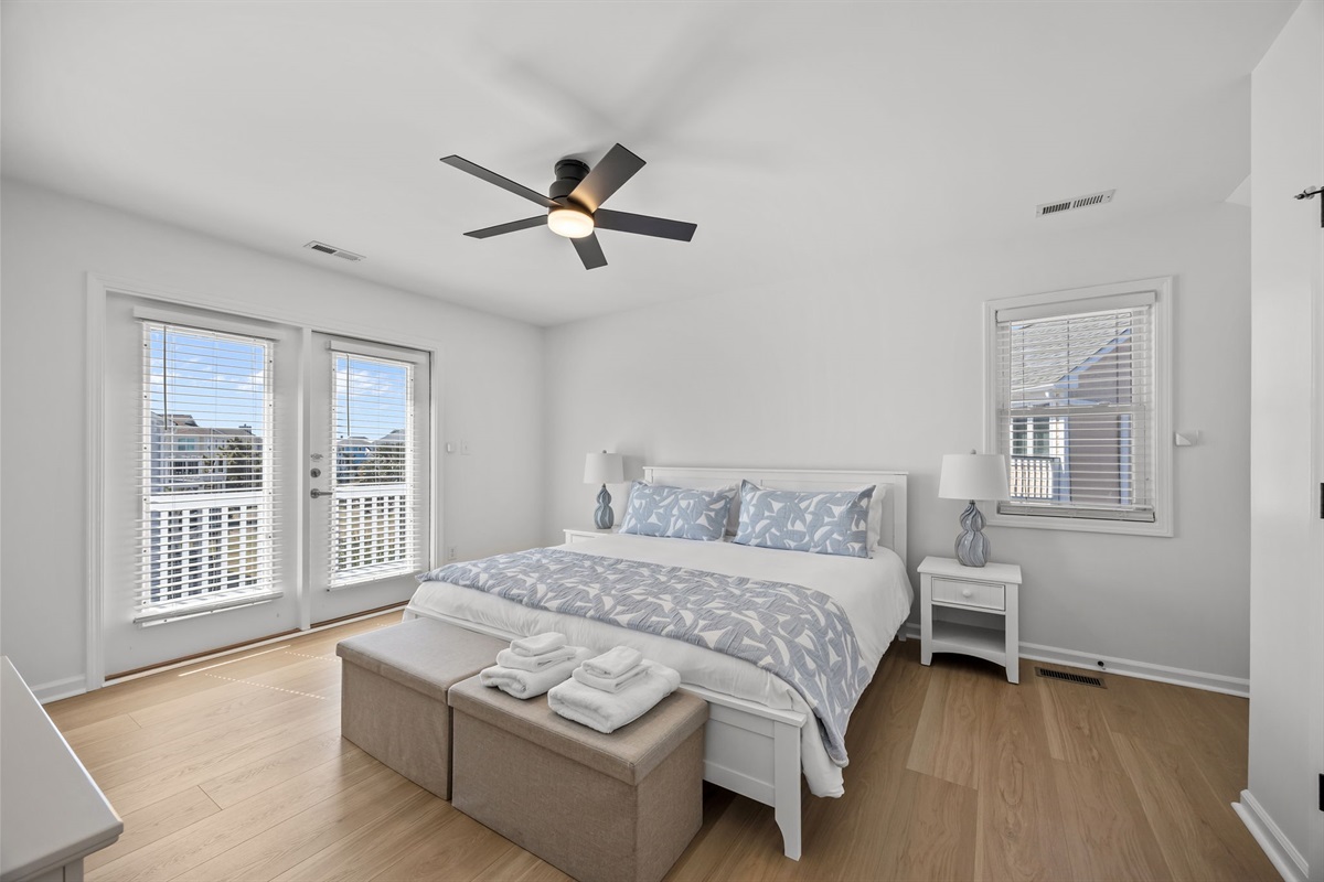 Second floor master bedroom with king bed and private balcony access