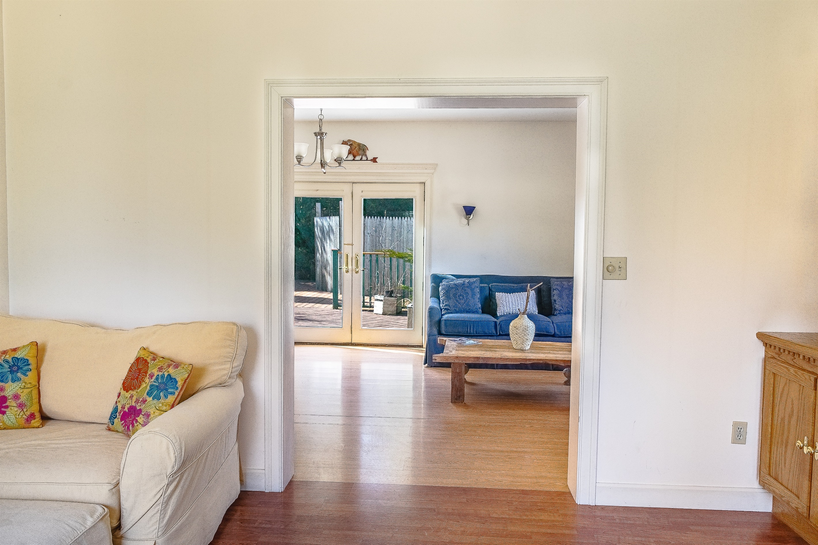 Enjoy the reverse view from the Driftwood Den, looking through the living room out to the sun-drenched deck. Sink into the large, comfy armchair—the perfect quiet corner for reading a book or watching the group gather in our open Southwest Harbor home.