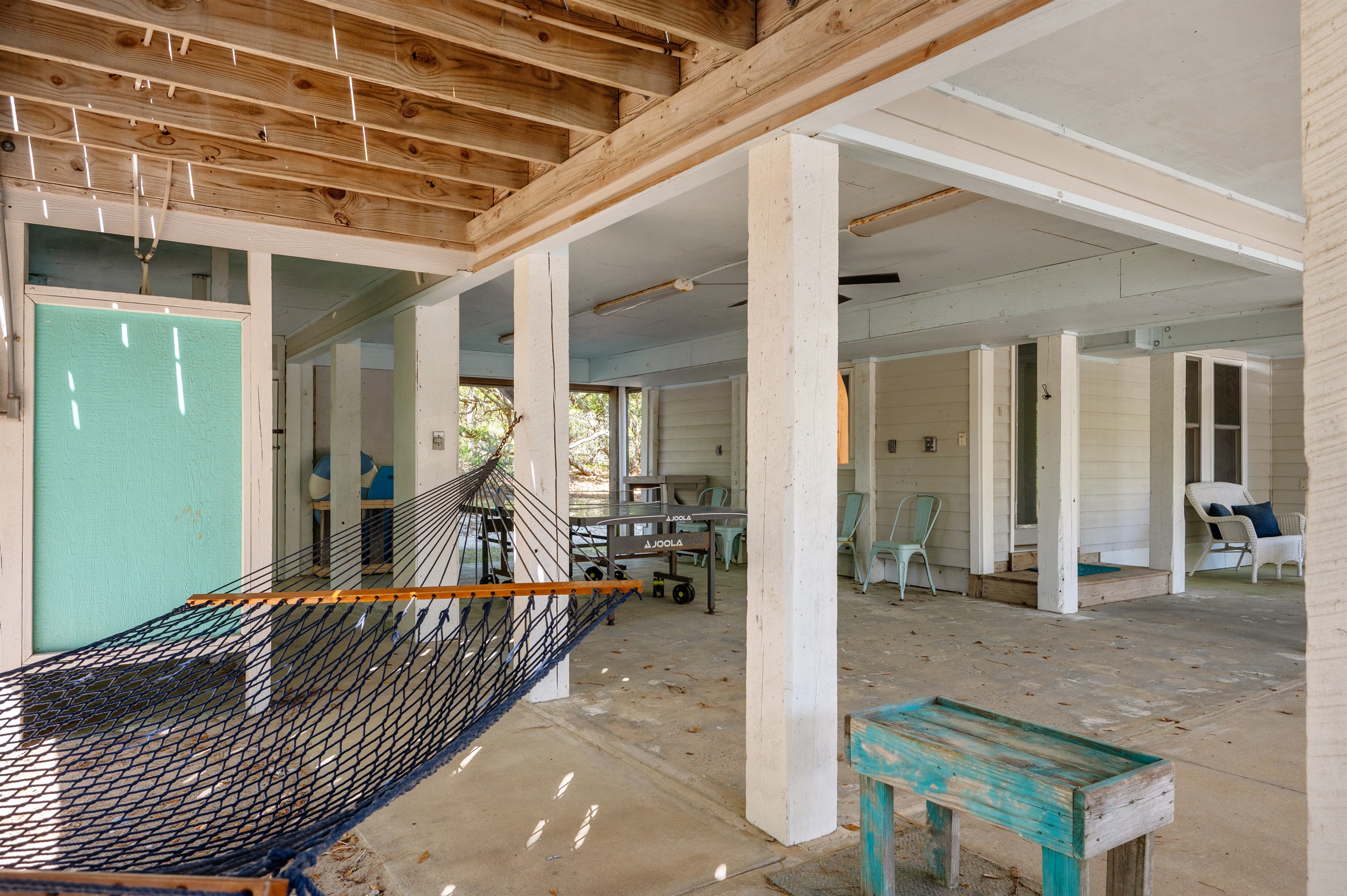 Relaxing hammock area tucked beneath the home for breezy afternoons in the shade.