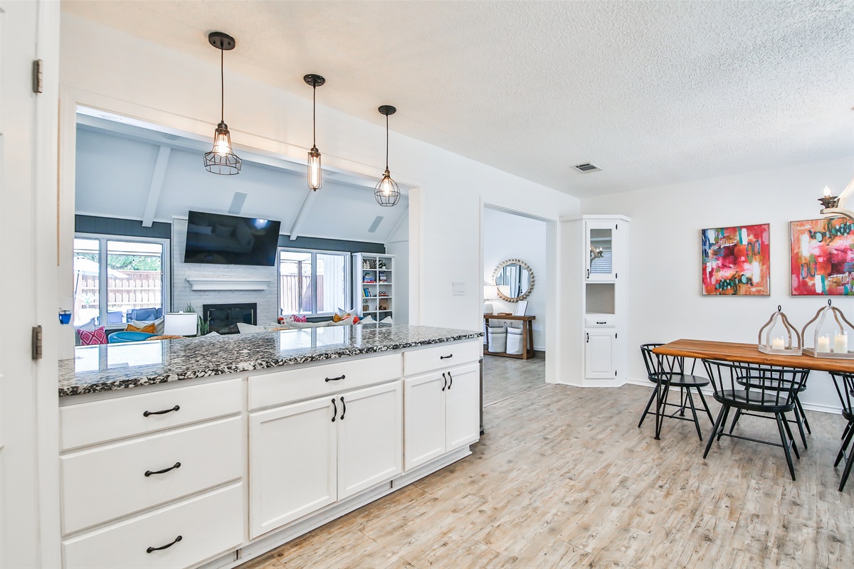 Kitchen with dining table and living room in the background 