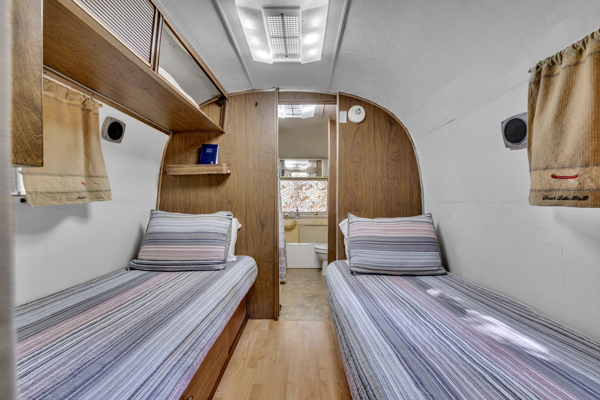 Cozy twin sleeping quarters inside the classic Airstream