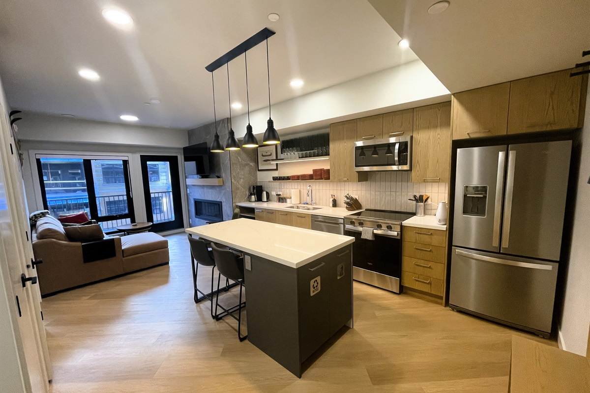 High end kitchen area, with granite counter tops. Stainless steel appliances include oversized fridge, glass-top range, stove, microwave, tea and coffee makers. Seating for four by the breakfast bar. Tastefully decorate with a mountain theme. 