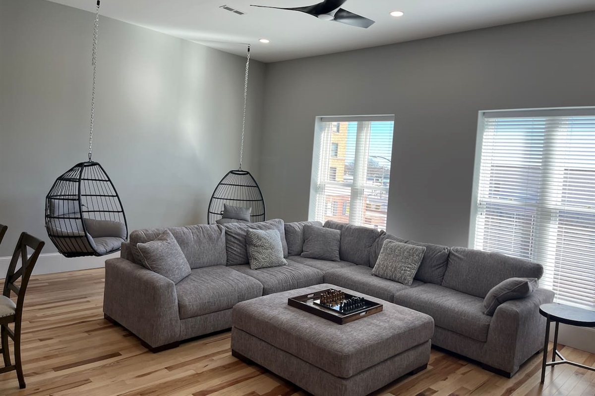 Relax in 1 of the 2 hanging chairs while enjoying the view of Main St in downtime Hays!